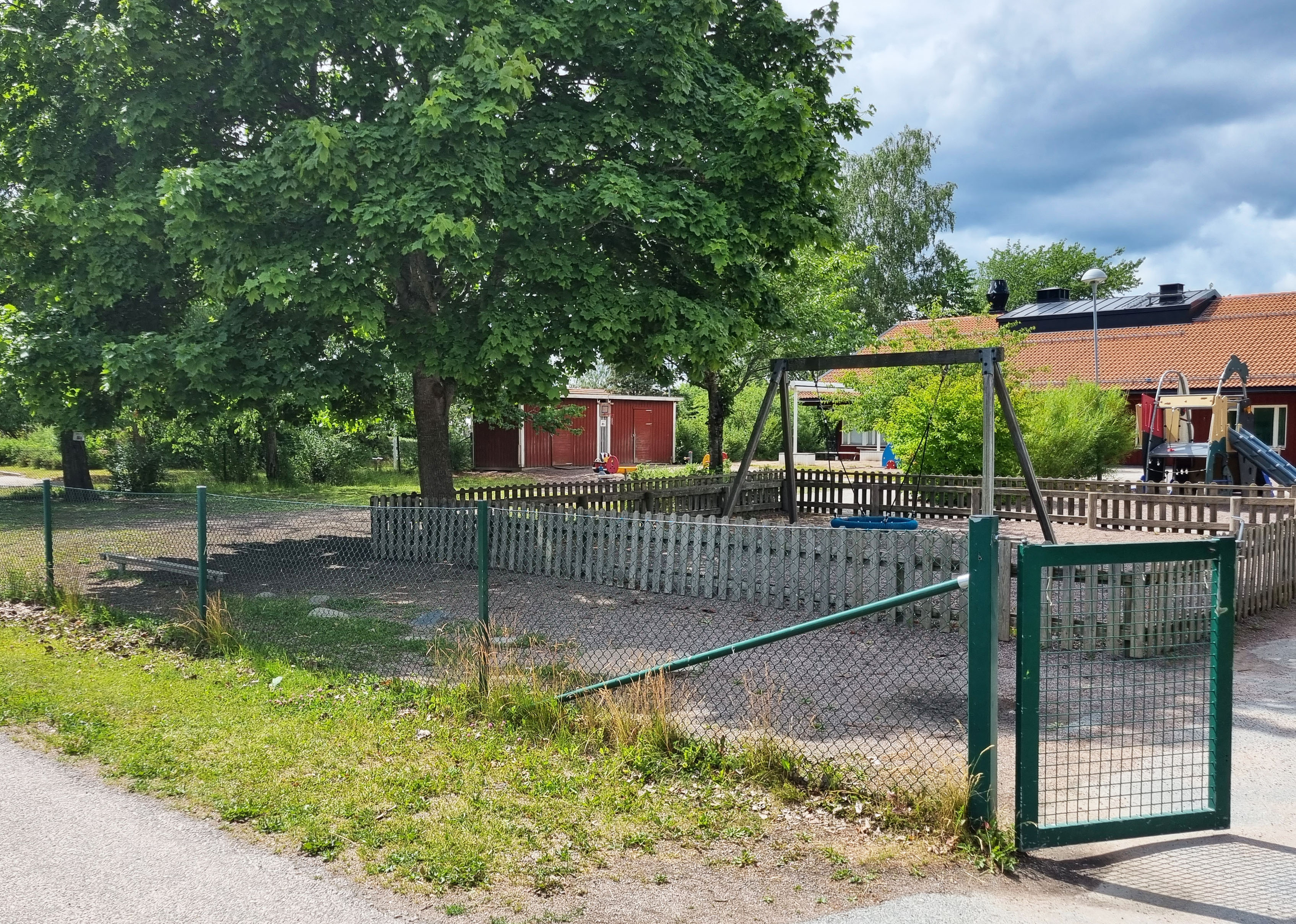 Sliten och igenvuxen förskolegård.