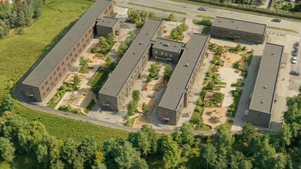 Illustration över en ny modulskola som ska byggas på en stor gräsyta.