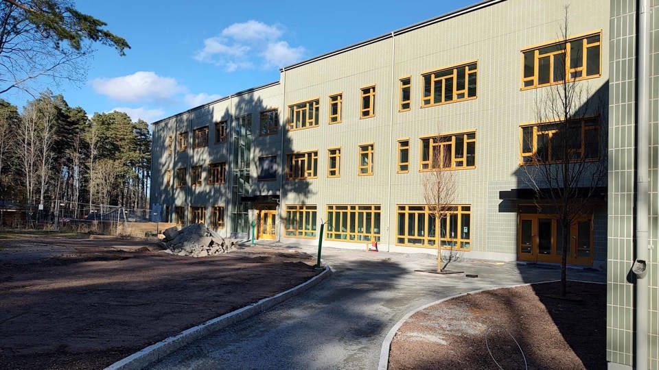 Grön skola och skolgård vid skogsparti